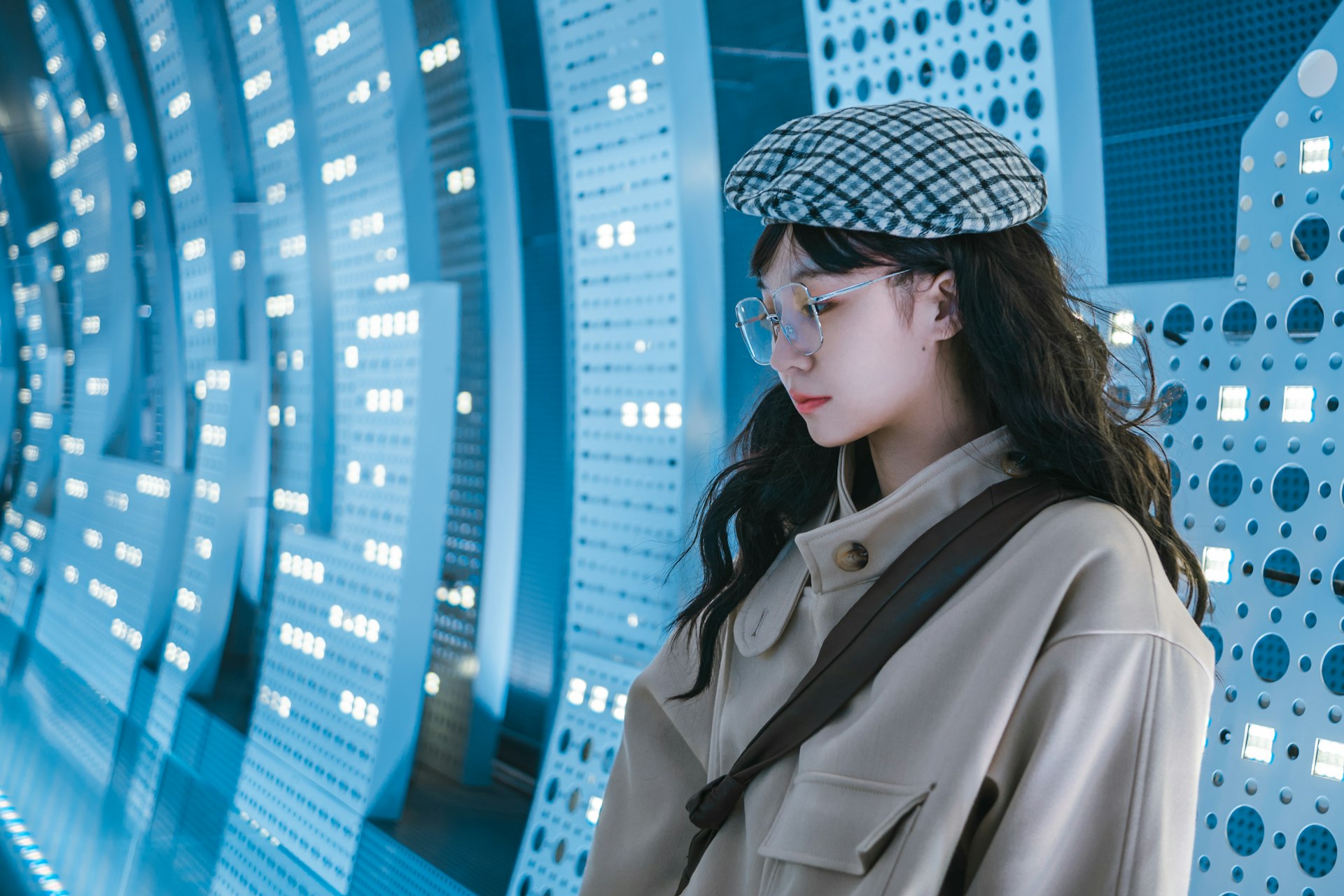 woman in brown coat wearing black and white knit cap